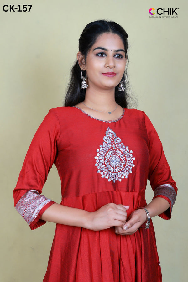 CK-157 MAROON COLOUR RAW SILK FABRIC FULL FLARE ANARKALI FIT & THILAGAM EMROIDERY WORK WITH SILVER ZARI TOP LENGTH-52' SLEEVE-16'