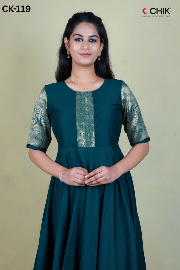 CK-119 BOTTLE GREEN  COLOUR RAW SILK FABRIC FULL FLARE ANARKALI FIT & ZARI BORDER WORK WITH FABRIC BALLS TOP LENGTH-52' SLEEVE-ELBOW LENGTH.